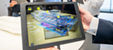 Bild von einem Tablet auf dem digitales Bauen ersichtlich ist. 