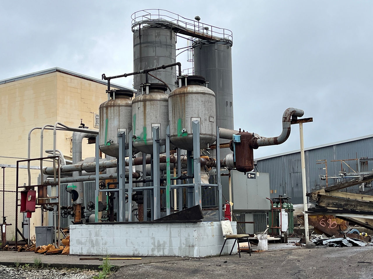Aging industrial site with damaged infrastructure before conversion to high-efficiency production facility