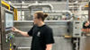 High School graduate operating machinery during apprenticeship