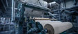 Industrial pulp and paper mill with piping systems supporting production operations