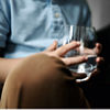 A child holds a glass of drinking water