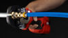 Installer using press tool on Viega MegaPress transition coupling connecting PEX and steel pipe