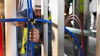 Contractor with hard hat installing PureFlow Fitting on blue pex line between studs