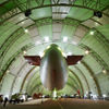 Vast dimensions: In the approximately 100 m long hangar in Essen-Mülheim, Germany, the blimps are maintained and, as shown here, fitted with new advertising logos. 