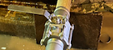Leaking piping system repaired under flow conditions to restore operation without shutdown