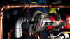 Milwaukee® M12™ FORCE LOGIC® Press Tool pressing a Viega MegaPress® fitting during a professional plumbing installation.