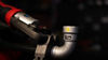 Close-up of a Milwaukee® pivoting press ring with a Viega MegaPress® elbow fitting for professional plumbing applications.