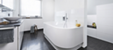 Die überzeugende Verwandlung: Eine trennende Vorwand gliedert architektonisch stilvoll den Raum und nimmt auf der einen Seite die Badewanne und auf der anderen Seite Dusche sowie im hinteren Bereich das WC auf. (Foto: Viega)