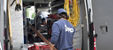 Plumber unloading copper pipes from work van full of tools