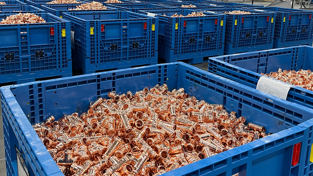 Blue bin filled with Viega ProPress fittings on automated production line in Ohio manufacturing facility